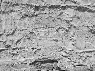 Texture white Concrete Wall with Brick. Smears of plaster on the Wall. Grunge background with space for text. Horizontal stone backdrop with copy space.