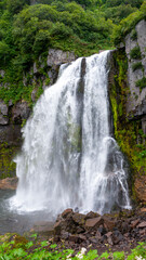 Fototapeta premium Russia, Kamchatka. A full-flowing mountain waterfall near Tolbachik volcano.