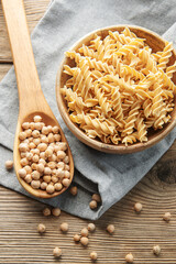 Chickpea bean fusilli pasta on a old wooden background.