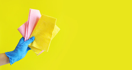 Viscose cleaning wipes. A woman's hand in a blue latex glove holds several cleaning wipes. Hand...