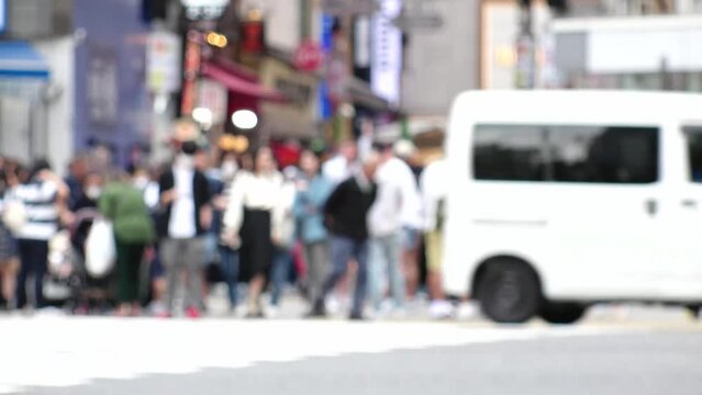 SHIBUYA, TOKYO, JAPAN -MAY 2023 : Crowd of people walking at Shibuya crossing. Busy downtown area in Tokyo. Japanese people, urban city life and metropolis concept 4K video. Time lapse shot in daytime