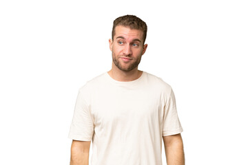 Fototapeta premium Young handsome caucasian man isolated on green chroma background making doubts gesture looking side