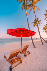 Romantic panoramic honeymoon destination, love couple chairs umbrella palm trees closeup sea sand sky. Tranquil coast, sunset relaxing beach, tropical landscape design. Summer colors, vacation travel