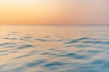 Sea wave closeup, low angle view, sunrise sunset sunlight. Idyllic Earth day seascape. Calm waves,...