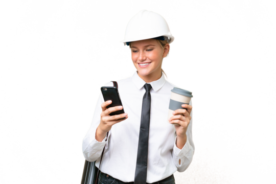 Young architect caucasian woman with helmet and holding blueprints over isolated background holding coffee to take away and a mobile