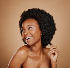 Thinking, black woman and hair care for afro, healthy and wellness in studio isolated on a brown background. Growth, hairstyle and happy African model with natural cosmetics after salon treatment.