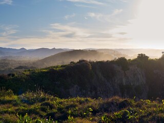 the sun shines over the mountains as it sets off from the horizon
