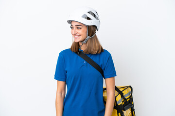 Young caucasian woman with thermal backpack isolated on white background looking side