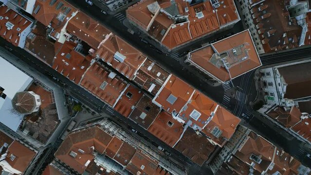 Aerial view of terracotta roof tiles of aged town buildings