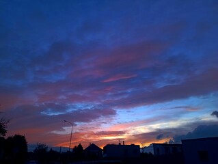 the sun is setting on a sky that has dark clouds