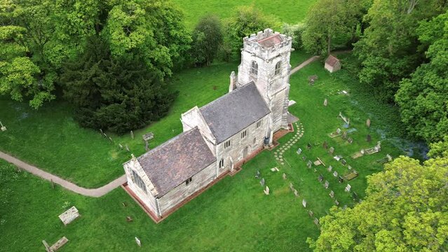 Aerial of the St Michael's Church, Baddesley Clinton in England next to a graveyard