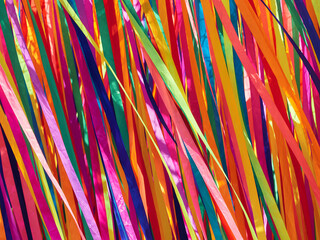 Multi-colored satin ribbons flutter in the wind