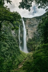 Scenic view of Gocta waterfall cascading through a lush and verdant jungle in Peru