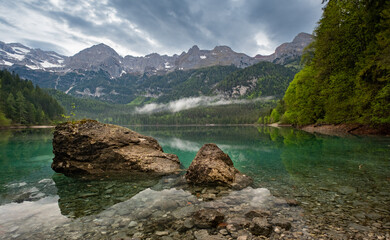 Lake Tovel in the Dolemites during a cloudy morning. Italy Travel. Hiking Destination. Landscape high quality. Beautiful Lake.