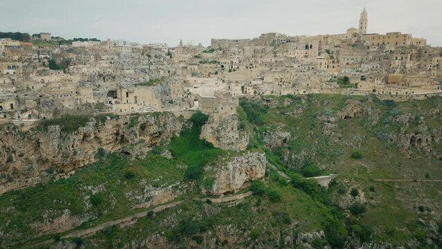 Drone shot of Murgia National Park with ruined stone buildings and caves on a hill