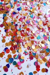 close-up shot of shiny confetti on white surface, created with generative ai