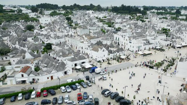 Drone footage of Alberobello town in Italy with white trulli huts