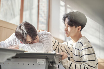 Obraz premium Young college student male model sleeping face down on a desk in a university classroom in Asia South Korea waking up boyfriend,colleague,motivation