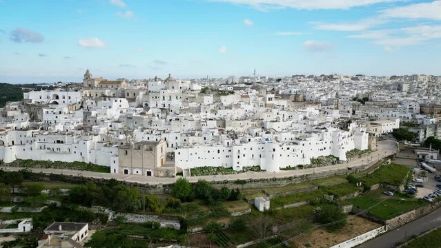Aerial of the white buildings of Brindisi city in Italy under the blue sky