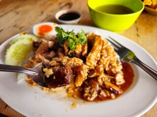 Rice with crispy pork and topped with red sauce 