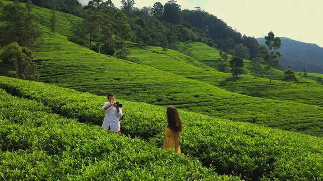 Young Couple of Travelers Making a Photo Shoot in Front of Sri Lankan Green Tea Terraces