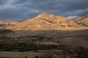 Scenic view of sunset over a mountain peak on a cloudy day