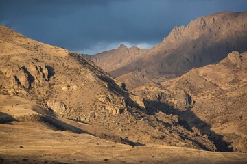 Scenic view of sunset over a mountain peak on a cloudy day