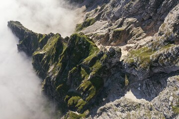 View of a mountain top from high showing clouds