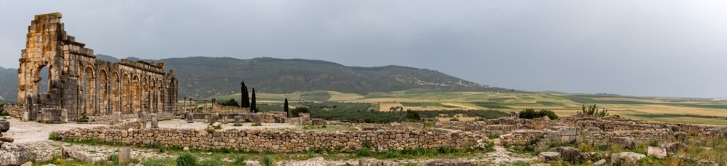 Fototapeta na wymiar Iconic ruins of the forum in Volubilis, an old ancient Roman city in Morocco