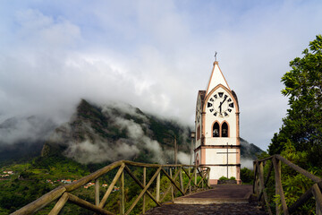 The chapel-tower Nossa Senhora de Fatima on top of green hills, Sao Vicente, Madeira island, Portugal - obrazy, fototapety, plakaty
