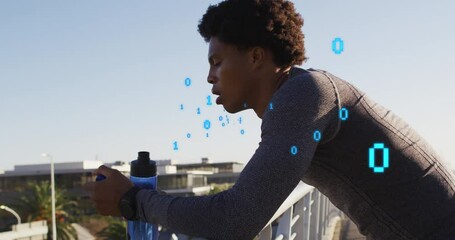 Animation of binary codes over african american male athlete drinking water on bridge against sky - Powered by Adobe