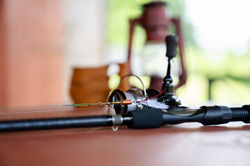 Close-up of a spinning rod on a wooden table