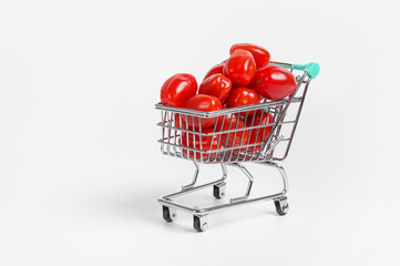 tomatoes in a shopping cart on a light background