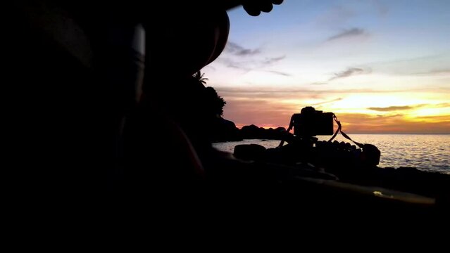 Video, background, local photographer filming the sunset in Kata, Karon beach in the Thai island of Phuket near the sea.