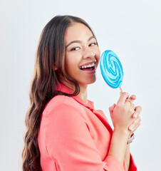 Portrait, lollipop and woman with sweets, funny and happiness against a white studio background. Face, female person or happy model with candy, dessert and laughing with a smile, humor and creativity