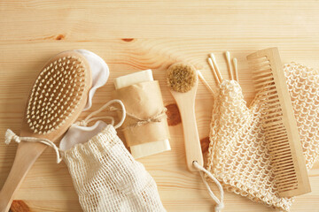 eco set for self-care, bamboo and tin items, cotton sponges and homemade soap on a wooden background