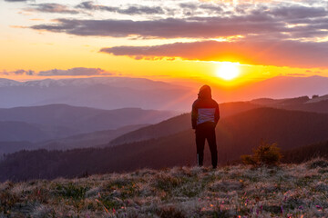 Obraz premium man, tourist on the background landscape in the mountains, sunset, silhouettes of the peaks, the Montenegrin Range, the Carpathians, travel, hikes, screen saver, poster, poster, spring, winter