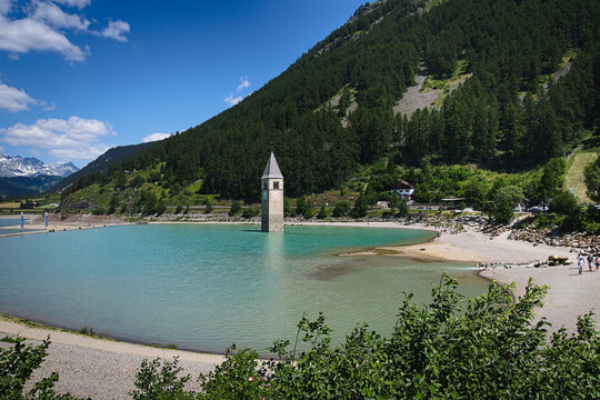 View of Lake Reschen ( Italian: Lago di Resia - German: Reschensee ) with the famous half-submerged bell tower of Graun im Vinschgau (Italian: Curon Venosta ). South Tyrol, Italy