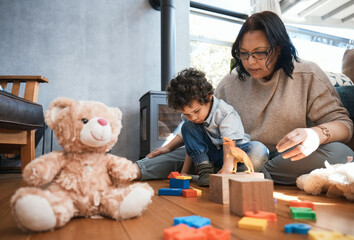 Toys, family or kids with a mother and son playing in the bedroom of their home together for child development. Children, teddy bear or education and a boy learning motor skills with a woman parent