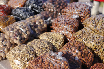 Close-up of assorted nuts and beans in the cellophane bags at bazaar