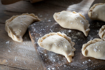 Homemade dumplings on a wooden cutting board