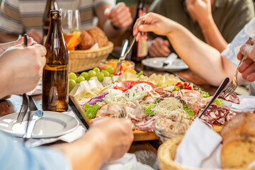 Close-up of a person eating a typical bavarian lunch at a beer garden in summer outdoors