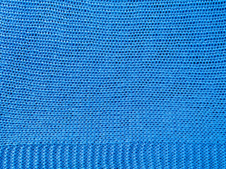 Knitted background.Texture of rough knitting from blue woolen threads