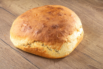 Homemade Ukrainian bread made from white wheat flour on a wooden table