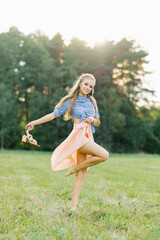 Fototapeta premium Woman holding shoes in her hands