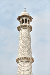 Minaret of Taj Mahal white marble mausoleum landmark in Agra, Uttar Pradesh, India, white tower