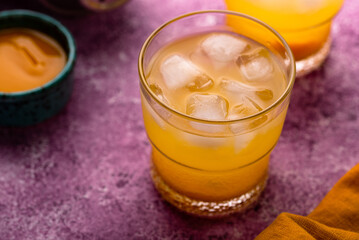 Summer cocktail with mango juice and ice
