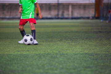 Obraz premium Soccer ball tactics children control the ball on a grass field for the training