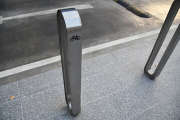 Aluminum Bicycle parking rack or bicycle stand near the road side with bicycle sign,  a device to...