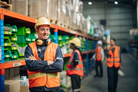 Shot of warehouse members collaborate daily to audit, examine inventory shipments. They organize and monitor storage, update checklists, and communicate effectively to ensure efficient distribution.